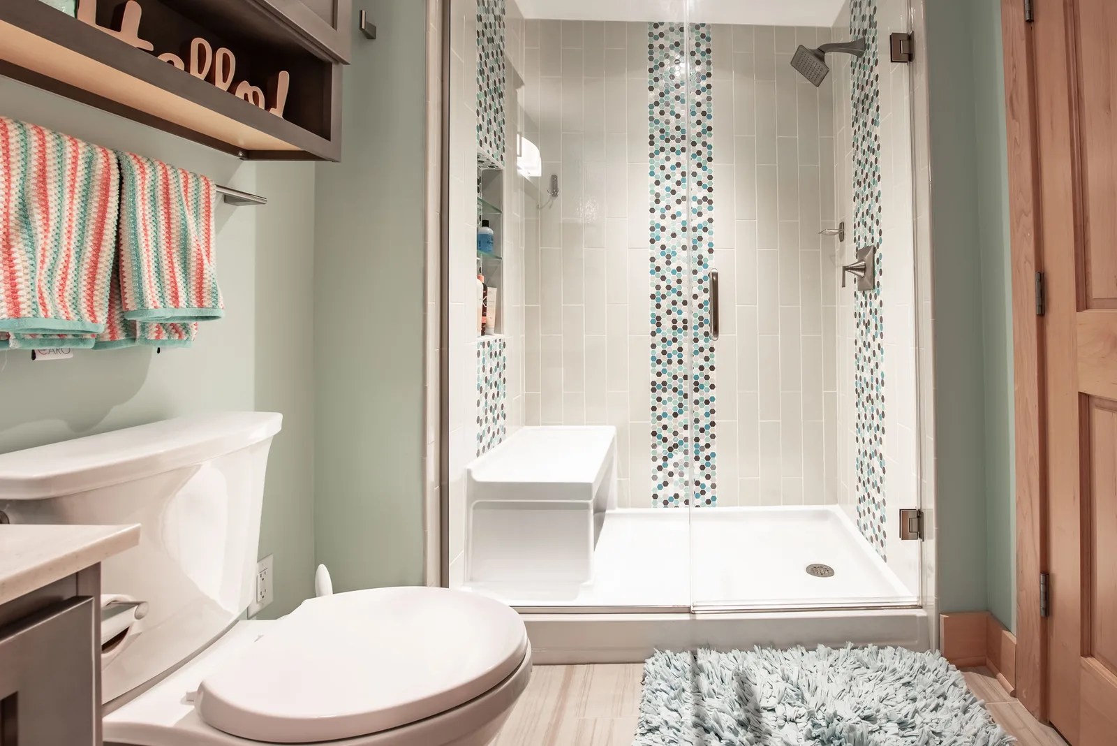Small remodeled bathroom with a walk-in shower, a white vanity and a deep green tile accent wall