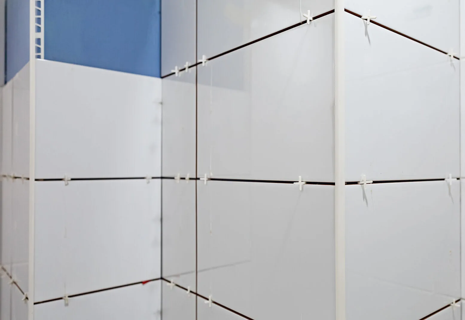 Wall tile set with plastic spacers holding even joints during a tile installation